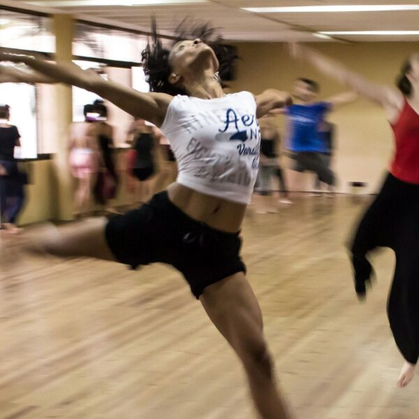 Dances dancing in a dance studio