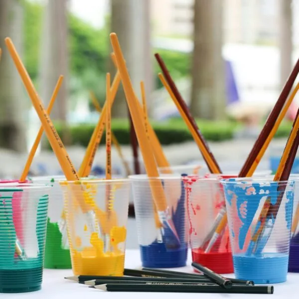 Plastic transparent cups holding coloured paint