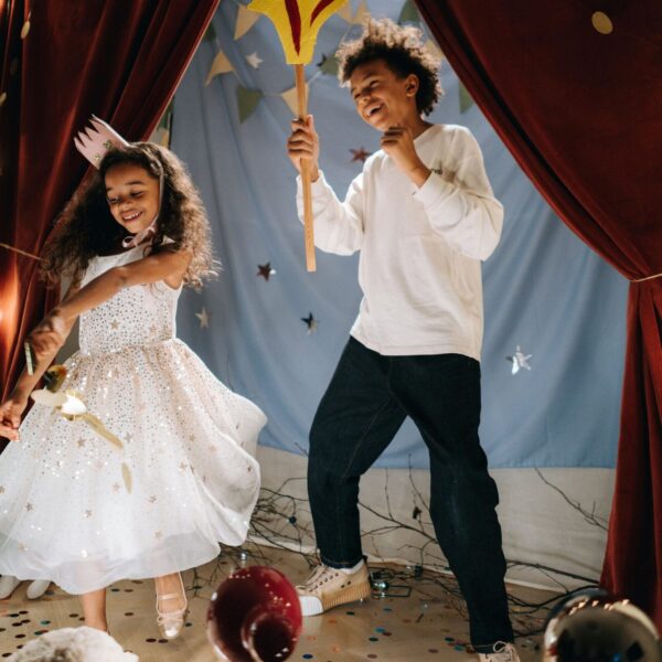 Two young children acting on a small stage