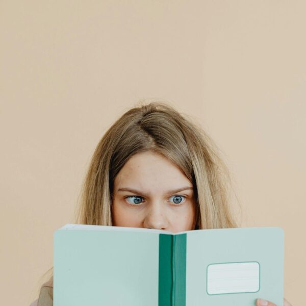 Teenage girl looking into a book