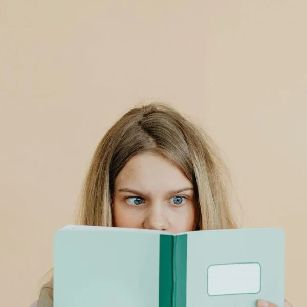 Teenage girl looking into a book