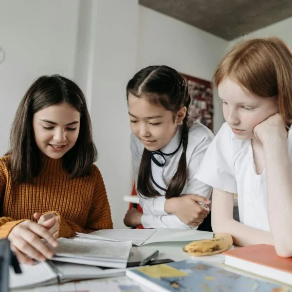 Three primary school girls learning together at home