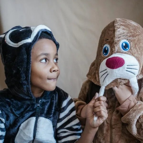 Two young children dressed up animal costumes
