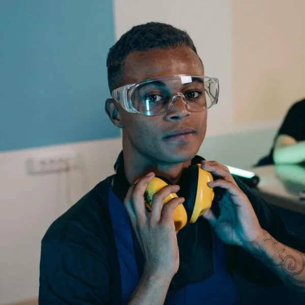 Teenage boy with ear defenders around his neck