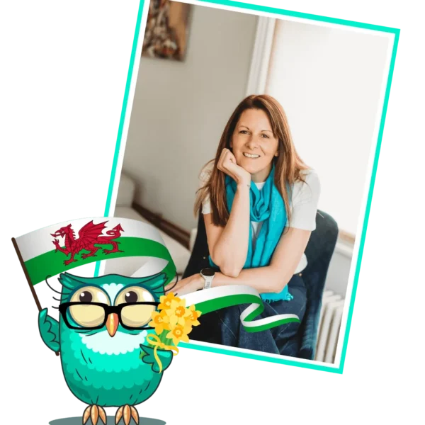 Lady thinking behind a cartoon Owl flying the Welsh flag
