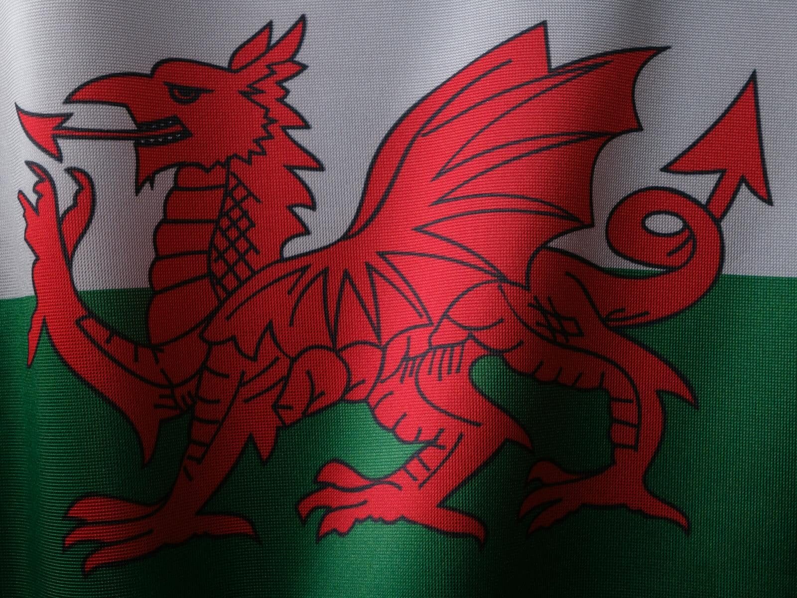 Detailed close-up of the Welsh flag featuring the iconic red dragon symbol.