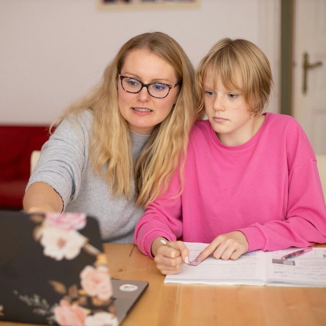 Home Education Packages girl in pink sweater beside girl in gray sweater